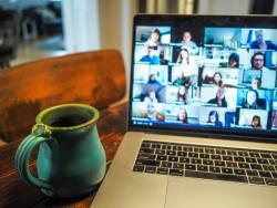 Cup sitting by laptop with a zoom meeting open